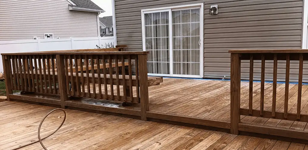 Deck sealing service protecting a backyard wood deck and railings in Rochester, NY