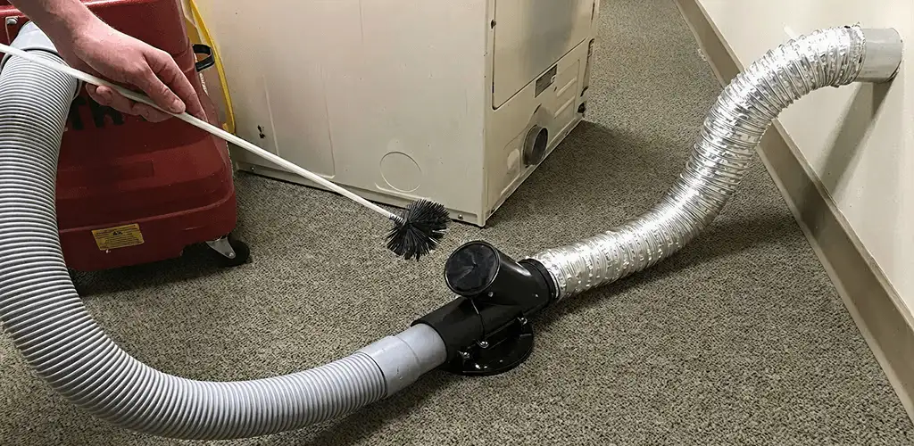 Dryer vent cleaning service removing lint from a dryer duct connection in Rochester, NY