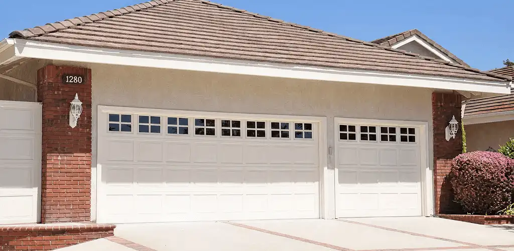 Residential garage door repair service for a double garage door in Rochester, NY