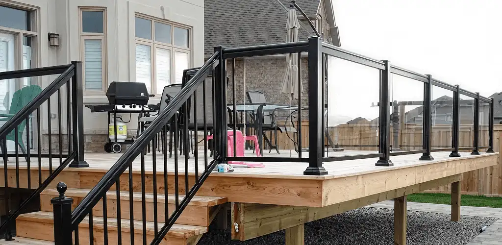 Handrail installation on a deck staircase for safety and code compliance in Rochester, NY