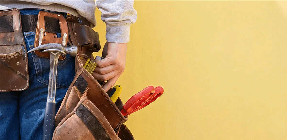 Handyman with tool belt ready for home repairs and maintenance in Rochester, NY