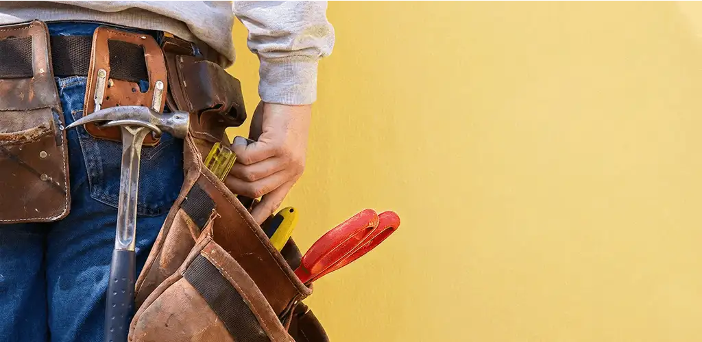 Handyman with tool belt ready for home repairs and maintenance in Rochester, NY