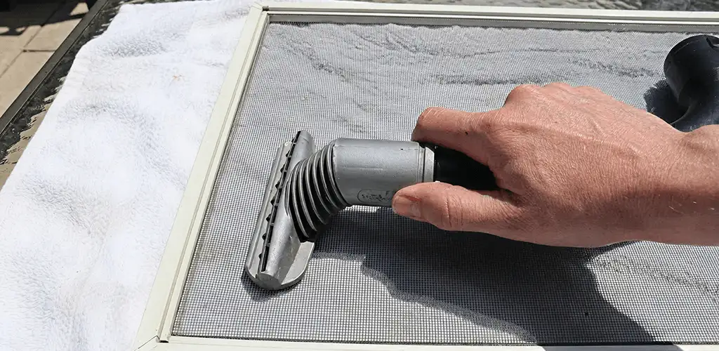 Window screen repair cleaning and fixing a damaged screen mesh in Rochester, NY